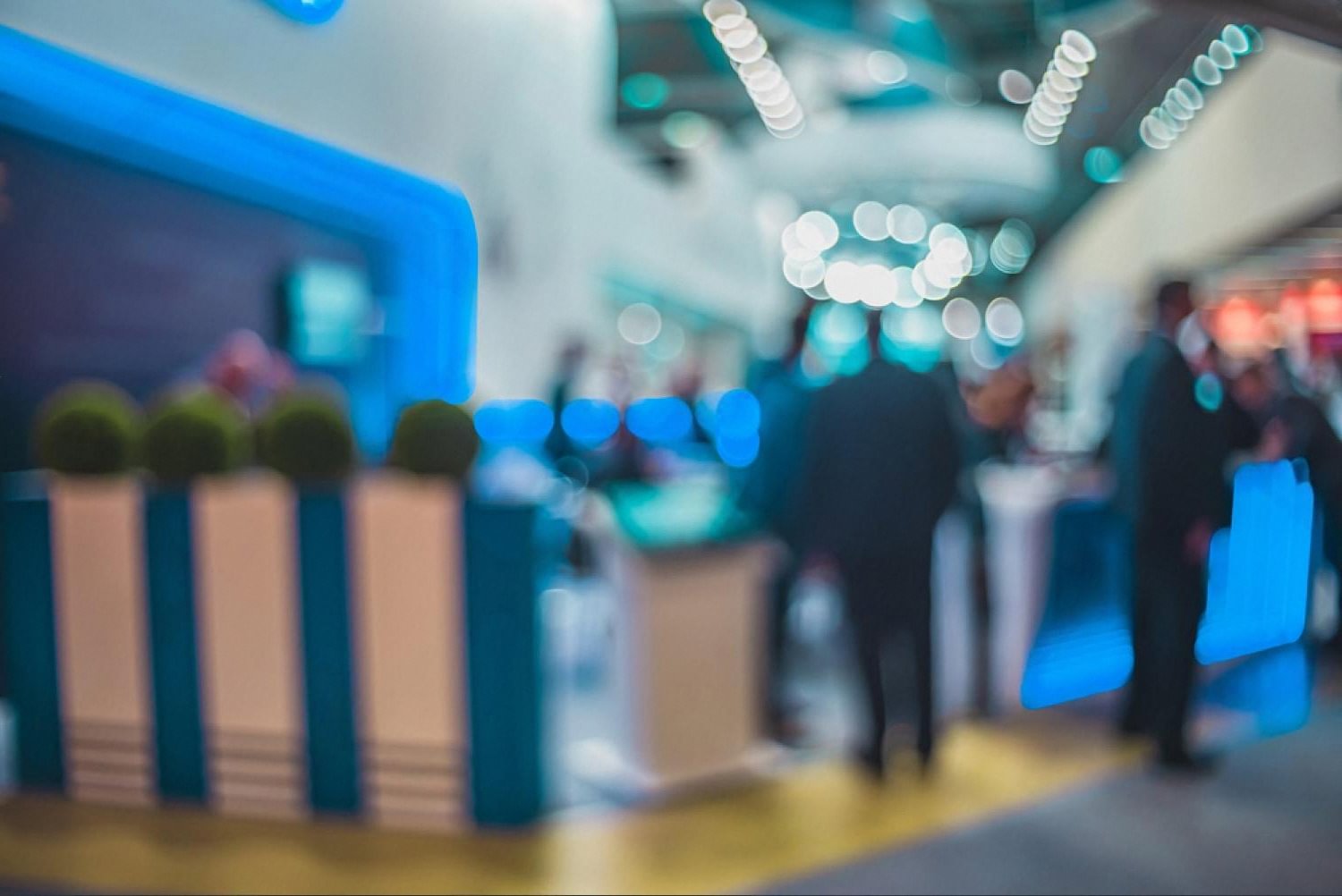 Indoor exhibition hall in Dubai cooled by portable AC units and blue accent lighting
