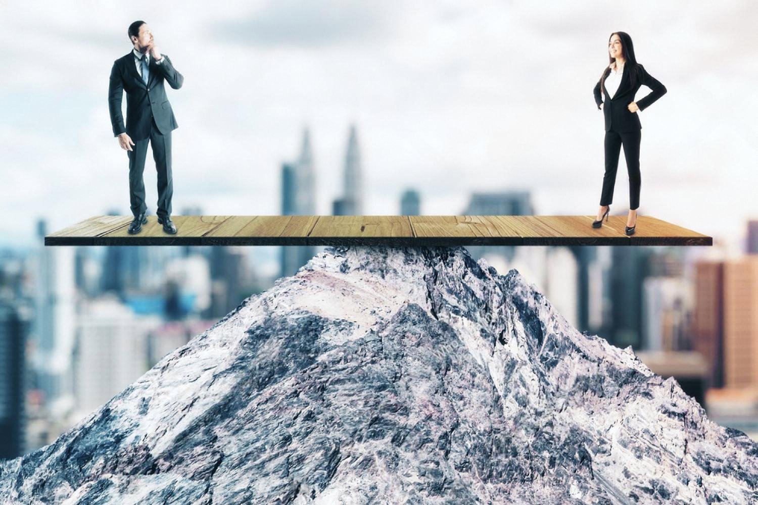 Two business people balanced on a wooden plank over a mountain peak, symbolising compliance risk balance